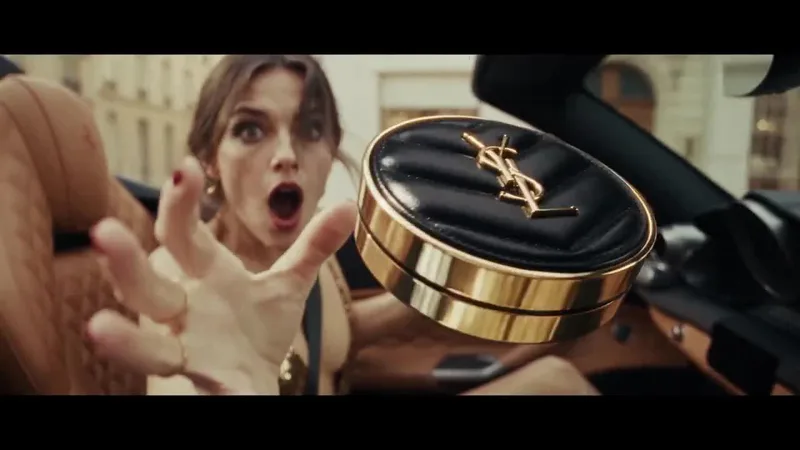 A compact powder case floating in slow motion as a woman reaches for it