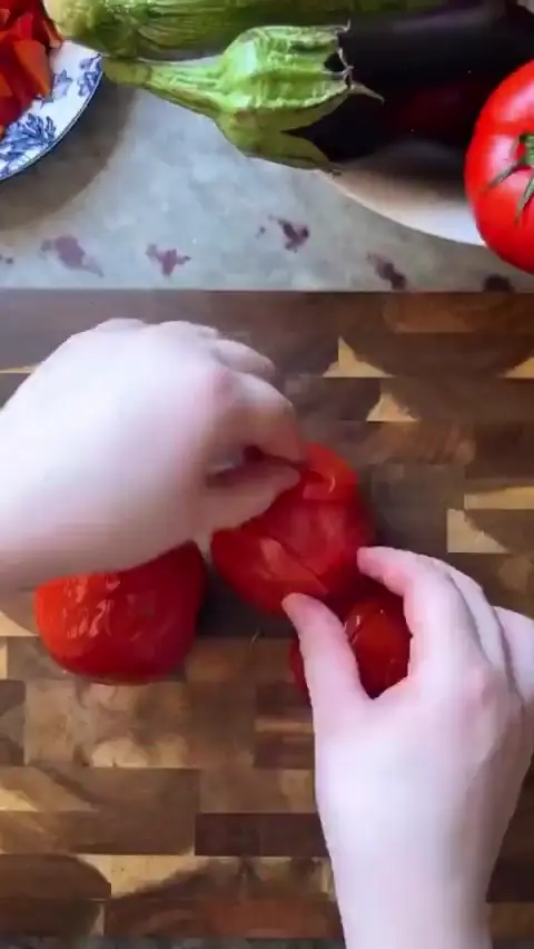 POV hands slicing tomatoes for ratatouille