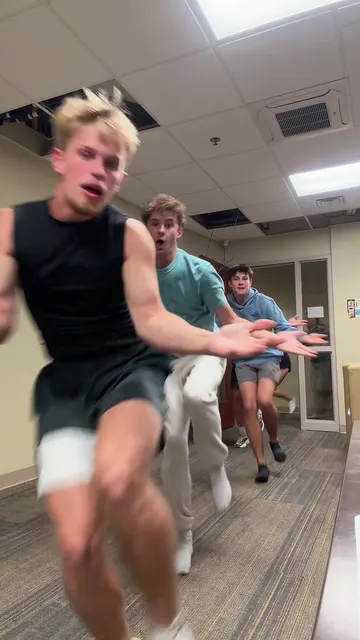 Knock knock dance trend: college group doing the Toc Toc dance down a dorm hallway